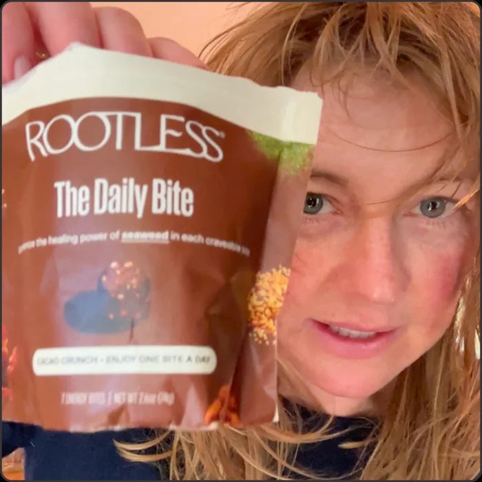 Woman holding a Rootless tin outdoors